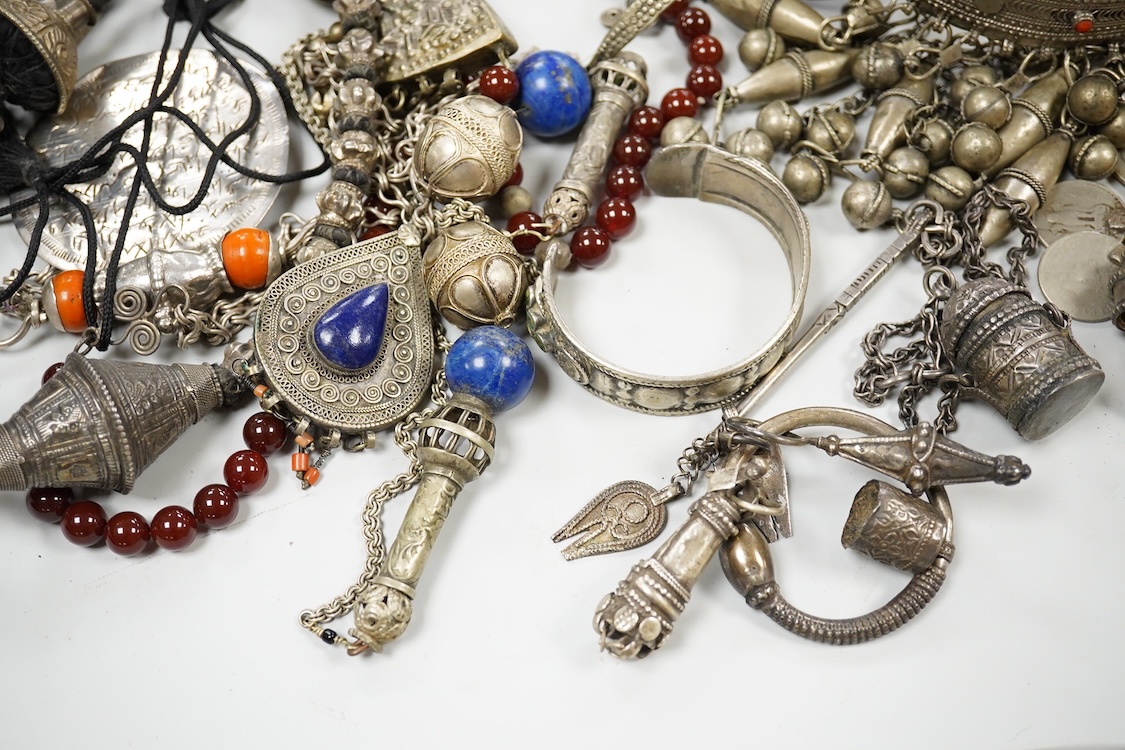 A collection of Bedouin white metal, gilt metal, lapis lazuli mounted jewellery, etc. from Oman